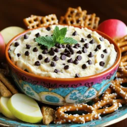 To make this tasty dip, gather these key ingredients: - 1 cup cream cheese, softened - 1/2 cup unsalted butter, softened - 3/4 cup brown sugar, packed - 1/4 cup granulated sugar - 1 teaspoon vanilla extract - 1 cup all-purpose flour (heat-treated for safety) - 1/2 cup mini chocolate chips These ingredients create a creamy, sweet base. The cream cheese and butter give it a rich texture. The sugars add sweetness, while the flour makes it thick. Heat-treating the flour ensures safety and enhances flavor. The mini chocolate chips provide delightful bursts of chocolate in each bite. You can customize your dip with these optional ingredients: - 1/4 cup chopped pecans or walnuts - Additional chocolate chips for garnish Adding nuts gives a nice crunch. You can also add more chocolate chips on top for extra sweetness. Feel free to get creative with your mix-ins. The dip is quite forgiving! For dippers, you have plenty of fun options: - Graham crackers - Apple slices - Pretzels - Vanilla wafers - Fresh strawberries These dippers offer a mix of flavors and textures. The sweetness of apples pairs well with the rich dip. Pretzels add a salty crunch, making each bite exciting. Arrange your dippers on a platter for a beautiful presentation. You can find the full recipe for Chocolate Chip Cookie Dough Dip above. Start by gathering all your ingredients. You need cream cheese, butter, sugars, flour, and chocolate chips. Make sure your cream cheese and butter are soft. This helps them mix well. In a medium bowl, beat the cream cheese and butter with an electric mixer. Mix until it feels fluffy and smooth. Gradually add the brown sugar and granulated sugar. Keep mixing until there are no lumps. Then, add in the vanilla extract and mix it in well. Next, mix in the heat-treated flour. This step is important for safety. If you haven’t heat-treated it yet, spread it on a baking sheet. Bake at 350°F for 5-7 minutes. Let it cool before adding. Finally, fold in the mini chocolate chips and nuts if you like them. Transfer your dip to a fun serving bowl. Smooth the top with a spatula. Now, chill it in the fridge for at least 30 minutes. This lets the flavors mix well and makes it firmer. After chilling, your dip is ready to enjoy! You can find the full recipe in the recipe section. To make the best Chocolate Chip Cookie Dough Dip, follow a few simple tips. First, use softened cream cheese and butter. This helps create a smooth texture. Next, heat-treat the flour for safety. Spread it on a baking sheet and bake it for 5-7 minutes at 350°F. Let it cool before mixing. When blending the ingredients, mix until there are no lumps. This ensures every bite is creamy and delicious. Lastly, chill the dip for at least 30 minutes. This step helps the flavors mix well and the dip firm up. Avoid some common mistakes to ensure your dip turns out great. Do not skip the heat treatment for the flour. Raw flour can make you sick. Another mistake is not mixing the sugar well. If you leave lumps, the dip won’t taste as good. Also, be careful not to overmix after adding the chocolate chips. This can break them apart. Finally, don't forget to chill the dip. If you serve it warm, it won't have the right taste or texture. Having the right tools makes making this dip easy. Here’s what you need: - Medium-sized mixing bowl - Electric mixer - Baking sheet - Spatula - Serving bowl - Plastic wrap for chilling These tools help you mix and serve your Chocolate Chip Cookie Dough Dip perfectly. For the full recipe, check the previous sections. Enjoy your tasty treat! {{image_2}} To make a gluten-free version, swap the all-purpose flour for gluten-free flour. This simple change makes it safe for those with gluten allergies. Use a blend that works well for baking. You can find many good options at the store. Just like the original, this version remains creamy and tasty. Want to mix it up? Try adding different flavors. For a nutty taste, add peanut butter. Just use half a cup and cut the butter in half. If you love chocolate, stir in Nutella. This adds a rich chocolate flavor and creaminess. You can also try adding coconut for a tropical twist. Each variation gives a new taste to your dip. Looking for a lighter option? Use Greek yogurt in place of cream cheese. This swap cuts fat and adds protein. Use the same amount of Greek yogurt as the cream cheese. The dip will still taste great and be a bit healthier. You can also cut down on sugar. Use honey or maple syrup instead. These swaps help keep the dip tasty while making it a bit better for you. For all these ideas, check the Full Recipe for the base ingredients and instructions. Enjoy exploring these variations! Once you finish enjoying your dip, store any leftovers in an airtight container. This keeps it fresh and prevents it from absorbing other odors in the fridge. Make sure to cover the top with plastic wrap before sealing the lid. This extra step helps keep the dip creamy. The dip lasts up to five days in the fridge. After that, the flavors may fade. If you want to keep it longer, you can freeze it. To freeze, spoon the dip into a freezer-safe container. Label it with the date. The dip can last up to three months in the freezer. To enjoy later, thaw it in the fridge overnight. You do not need to reheat this dip. It tastes best cold or at room temperature. If you freeze it, let it thaw completely before serving. You can mix it again if it seems too thick after thawing. This will help bring back the creamy texture. You should not eat raw flour. It can contain harmful bacteria. To keep it safe, heat-treat the flour. Spread it on a baking sheet and bake for 5-7 minutes at 350°F. This process kills any bad germs. The fun part of this dip is the dippers! You can use many things. My favorites are: - Graham crackers - Apple slices - Pretzels - Vanilla wafers - Strawberries These dippers add flavor and texture. You can mix and match them for variety! You can keep this dip in the fridge for up to five days. Make sure to store it in an airtight container. This keeps it fresh and safe to eat. If it starts to smell off or changes color, throw it away. You can find the full recipe for Chocolate Chip Cookie Dough Dip above. It has all the details you need to make this tasty treat. You now know how to make a delicious chocolate chip cookie dough dip. We covered key ingredients and fun ways to customize it. I shared tips to help you avoid common mistakes. You can even try health-conscious variations if you want. Storing leftovers is easy, and I answered your top questions. Enjoy making this treat for parties or snacks. With these steps, you’ll impress everyone with your dip!