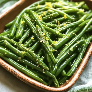 Here’s what you need for garlic butter green beans. This dish is simple and quick to make. - 1 pound fresh green beans, trimmed - 4 tablespoons unsalted butter - 4 cloves garlic, minced - 1 teaspoon lemon zest - 1 tablespoon lemon juice - Salt and pepper to taste - 1/4 teaspoon crushed red pepper flakes (optional) - 1 tablespoon toasted sesame seeds (for garnish) These ingredients come together to create a delicious side dish. The fresh green beans give great color and crunch. The garlic adds strong flavor. Butter makes everything rich and tasty. Lemon zest and juice brighten the dish. Red pepper flakes add spice if you like it hot. Sesame seeds give a nice crunch on top. You can find the full recipe with steps after gathering these ingredients. Enjoy making this easy and tasty addition to any meal! - First, wash the green beans under cold water. - Next, trim the ends of the green beans. - In a large pot, bring salted water to a boil. - Blanch the green beans in the boiling water for 3-4 minutes. - When they are bright green and tender, drain them. - Quickly place the beans in ice water to stop cooking. - After cooling, drain again and set aside. - In a large skillet, melt the butter over medium heat. - Once melted, add the minced garlic to the butter. - Sauté the garlic for 1-2 minutes until it smells great. - Be careful not to let the garlic burn. - Add the blanched green beans to the skillet. - Toss the beans gently with the garlic butter. - Sprinkle in lemon zest, lemon juice, salt, and pepper. - If you like heat, add crushed red pepper flakes. - Toss everything for another 2-3 minutes to mix well. - Remove the skillet from heat. - Transfer the green beans to a serving dish. - Garnish with toasted sesame seeds for a nice crunch. - Serve the garlic butter green beans warm and enjoy! For the complete recipe, check out the Full Recipe. - To blanch green beans, boil salted water. Add green beans for 3-4 minutes. - Quickly transfer them to ice water to stop cooking. This keeps their bright color. - To prevent garlic from burning, sauté it on medium heat. Stir constantly for 1-2 minutes. - You can modify the seasonings. Add a pinch of garlic powder for extra flavor. - Use fresh herbs like thyme or rosemary for a twist. - For the best taste, sauté at medium heat. This allows the garlic to infuse the butter. - Garlic butter green beans pair well with chicken or steak. They add a fresh touch. - Serve them warm for the best experience. The flavors shine when they are fresh. - You can also serve them alongside rice or pasta for a complete meal. For the full recipe, check out the detailed instructions above. {{image_2}} You can switch the butter for olive oil if you want a lighter dish. Olive oil adds a nice taste and is a bit healthier. You can also try other oils like avocado or coconut oil. For add-ins, consider using nuts like toasted almonds or walnuts. They add crunch and extra flavor. Fresh herbs also work well. Try thyme, basil, or dill for a pop of freshness. To change the taste, add different spices. A pinch of cumin or paprika can give a warm touch. Soy sauce or balsamic vinegar can add depth too. You can also mix in other veggies. Carrots, bell peppers, or mushrooms can enhance color and flavor. Just remember to cook them until tender. For a fun twist, serve garlic butter green beans cold in a salad. Just let them cool after cooking. They pair well with a light vinaigrette and other veggies. Another idea is to use the green beans in pasta or grain salads. Toss them with cooked pasta, couscous, or quinoa. This adds a hearty element to your meal. For the full recipe, check out the detailed steps above! Store any leftover garlic butter green beans in an airtight container. Place them in the refrigerator. They will stay fresh for up to three days. When you are ready to eat them, just reheat. You can freeze garlic butter green beans for later use. To do this, let them cool completely. Then, pack them in a freezer-safe bag or container. Squeeze out as much air as possible to prevent freezer burn. They will keep well for about three months. When reheating, first thaw them in the fridge overnight. Then, warm them in a skillet on low heat until hot. Refrigerated green beans last about three days. Frozen green beans maintain their best quality for up to three months. After that, they may still be safe but lose flavor and texture. Always check for signs of spoilage before using. To make garlic butter green beans, start by washing and trimming the green beans. Blanch them in boiling salted water for about 3-4 minutes. This step keeps the beans vibrant and slightly tender. After blanching, plunge them into ice water to stop the cooking. Once cooled, drain them and set aside. In a skillet, melt unsalted butter over medium heat. Add minced garlic and sauté until fragrant but not burnt. Toss in the blanched green beans with lemon zest, lemon juice, salt, and pepper. Cook for another 2-3 minutes until heated through. For a final touch, garnish with toasted sesame seeds. This simple method creates a tasty side dish that pairs well with many meals. Yes, you can use frozen green beans. They are convenient and still tasty. When using frozen beans, there’s no need to blanch them first. Just sauté them directly in the skillet with the melted butter and garlic. They may take a bit longer to cook through, so add a few extra minutes to your sauté time. If you use frozen beans, make sure to drain any excess water that may release during cooking. This helps maintain that rich garlic butter flavor. Garlic butter green beans pair beautifully with many dishes. They complement grilled chicken, steak, or fish perfectly. You can also serve them alongside roasted meats or even pasta dishes. If you want a vegetarian meal, try them with a quinoa salad or a hearty grain bowl. Their bright flavor adds a nice contrast to rich dishes. Yes, garlic butter green beans are a healthy choice. Green beans are low in calories and high in fiber. They provide vitamins A, C, and K, which are great for your health. Garlic offers its own benefits, like boosting the immune system. While butter adds flavor, you can use less for a lighter option. Just remember to enjoy them as part of a balanced diet. You can easily make this recipe vegan! Instead of butter, use olive oil or a plant-based butter. This swap keeps the rich flavor while making the dish suitable for vegans. You can also add a bit of nutritional yeast for a cheesy taste. Try adding fresh herbs like parsley or basil to enhance the flavor. Making these small changes keeps your dish delicious and vegan-friendly. Check out the Full Recipe for more tips! This blog post covered making garlic butter green beans. You learned about the ingredients, step-by-step cooking, tips, variations, storage, and FAQs. This dish is simple yet packed with flavor. You can customize it with different spices or oils. It's a great side for many meals. Whether fresh or frozen, you now have options to enjoy this recipe. So gather your ingredients, and have fun cooking! Enjoy your delicious creation!
