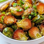 To make Air Fryer Honey Garlic Brussels Sprouts, you need a few simple ingredients. Here’s what to gather: - 1 pound Brussels sprouts, trimmed and halved - 2 tablespoons olive oil - 2 tablespoons honey - 3 cloves garlic, minced - 1 teaspoon soy sauce - 1/2 teaspoon salt - 1/4 teaspoon black pepper - Optional garnishes: sesame seeds, chopped green onions Each ingredient plays a key role in building flavor. The Brussels sprouts bring a nice crunch. Olive oil helps them crisp up in the air fryer. Honey adds sweetness, while garlic gives a savory kick. Soy sauce adds depth, and salt and pepper enhance all the flavors. If you want, sesame seeds and green onions make great toppings for extra flair! Gather these items before you start. It makes cooking easier and more fun! First, set your air fryer to 375°F (190°C). This step ensures the sprouts cook evenly. Preheating takes just a few minutes, but it's key for crispiness. Next, take 1 pound of Brussels sprouts. Trim the ends and cut them in half. This helps them cook faster and get crispy. In a bowl, mix the halved sprouts with 2 tablespoons of olive oil, 2 tablespoons of honey, and 3 cloves of minced garlic. Add 1 teaspoon of soy sauce, 1/2 teaspoon of salt, and 1/4 teaspoon of black pepper. Toss well until each sprout is coated. Now it’s time to cook! Place the Brussels sprouts in the air fryer basket. Make sure they are in a single layer. Avoid overcrowding for better results. Cook for 15-18 minutes. Halfway through, shake the basket. This helps them crisp up evenly. When done, the sprouts should be golden brown and crispy outside. - Tips for shaking the basket: - Gently lift and shake the basket. - Aim to move them around every 7-8 minutes. - This action helps all sides cook evenly. Once they're ready, take them out and place them on a serving dish. Drizzle any remaining honey over the top. Finish by sprinkling with sesame seeds and chopped green onions for a fresh touch. Enjoy your Air Fryer Honey Garlic Brussels Sprouts! To get that perfect crunch, start by cutting the Brussels sprouts in half. This helps them cook evenly. Make sure to coat them well with olive oil and honey. Oil creates a crispy texture, while honey adds a nice sweet touch. Cook them in a single layer in the air fryer. This step prevents steaming and gives you that golden brown look. Shake the basket halfway through cooking. This action ensures all sides get that delightful crispiness. You can easily switch up the flavors to match your taste. For a spicy kick, add red pepper flakes to the mix. If you prefer a tangy twist, try adding a splash of lemon juice. You can also swap honey for maple syrup if you want a different sweetness. For a nutty flavor, sprinkle in some chopped nuts or seeds before serving. This flexibility makes it fun to experiment with your Brussels sprouts! These Brussels sprouts can shine as a side dish or a main event. Serve them alongside grilled chicken or fish for a balanced meal. You can also toss them in a salad for extra crunch. If you want a fancy touch, serve them on a platter with a drizzle of balsamic glaze. Pair them with rice or quinoa for a filling vegetarian option. The possibilities are endless, and they look lovely on any table! {{image_2}} You can switch honey for other sweeteners. Maple syrup adds a unique flavor. Agave nectar works well too. Both create a lovely glaze. Each option brings its own taste. Try different sweeteners to find your favorite. Want to spice things up? Add red pepper flakes for heat. Smoked paprika gives a nice depth. You might also try cumin for a warm finish. Experiment with spices to match your taste. A little goes a long way in adding complexity. This dish is simple to make vegan. Just replace honey with agave or maple syrup. You can also use soy sauce or tamari for saltiness. This keeps the dish flavorful and plant-based. Enjoy the same tasty results without animal products. After you enjoy your Air Fryer Honey Garlic Brussels Sprouts, store leftovers in an airtight container. Keep them in the fridge. They stay fresh for up to three days. Make sure they cool down before sealing the container. This helps keep them crispy for your next meal. To reheat, use the air fryer again. Set it to 350°F (175°C). Place the Brussels sprouts in the basket for about 5 minutes. This helps them regain their crunch. You can also use the microwave, but they may lose some crispiness. Heat in 30-second intervals until warm. If you want to freeze your Brussels sprouts, do it right after cooking. Cool them completely first. Place them in a freezer-safe bag or container. They can last up to three months. When ready to eat, thaw them in the fridge overnight. Reheat them in the air fryer for the best taste. You should cook Brussels sprouts in the air fryer for 15 to 18 minutes. This time will make them crispy and golden brown. Remember to shake the basket halfway through. This step helps them cook evenly. If your sprouts are bigger, you may need a few extra minutes. Yes, you can use frozen Brussels sprouts! Just cook them a bit longer. Frozen sprouts may take 20 to 25 minutes. Make sure to check for crispness. You may want to skip the oil if they are icy. You can cook many vegetables in the air fryer! Here are a few favorites: - Broccoli - Cauliflower - Carrots - Zucchini - Bell peppers These veggies also make great side dishes. Each type may need different cooking times. If your Brussels sprouts are large, cook them longer. For small or medium sprouts, keep the time shorter. Generally, the bigger the sprout, the more time it needs. Always check for crispness. A fork should easily pierce them when done. This guide showed you how to cook Brussels sprouts in an air fryer. We covered the best ingredients, step-by-step instructions, and tips for crispy results. You learned how to customize flavors and store leftovers. Remember, the right prep and cooking make a big difference. Enjoy your tasty Brussels sprouts! Try new flavors and share your results with others. Happy cooking!