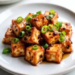 - 1 block (14 oz) firm tofu, drained and pressed - 1/4 cup honey - 3 cloves garlic, minced - 2 tablespoons vegetable oil - 3 tablespoons cornstarch - 2 tablespoons soy sauce - 1 tablespoon sriracha (adjust to taste) - 1 tablespoon rice vinegar - 1/2 teaspoon ground ginger - 1/4 teaspoon black pepper - Green onions and sesame seeds for garnish This dish starts with firm tofu. You need to drain and press it well. This step helps the tofu soak up flavors. The honey brings natural sweetness. Garlic adds a punch! Together, they create a rich sauce. For cooking, you need vegetable oil. It helps fry the tofu and makes it crispy. Cornstarch is key for a crunchy texture. Don't skip it! Soy sauce adds saltiness and depth. Now, let's spice it up! Sriracha gives heat. You can adjust it based on your taste. Rice vinegar adds tanginess. Ground ginger gives warmth. Black pepper adds a hint of spice. Finally, garnish with green onions and sesame seeds for a pop of color and crunch. {{ingredient_image_1}} 1. Preheat your oven to 400&deg;F (200&deg;C). This step is key for crispy tofu. 2. Line a baking sheet with parchment paper. This will help prevent sticking. 3. Drain and press the tofu to remove excess water. This makes it firmer. 4. Cut the tofu into bite-sized cubes. Aim for even pieces for even cooking. 1. Sprinkle cornstarch over the tofu cubes. Make sure each piece is coated well. 2. In a large skillet, heat vegetable oil over medium-high heat. 3. Add tofu cubes in batches. Fry until golden brown, about 8-10 minutes. Flip them to cook all sides. 4. Remove the crispy tofu and place it on the prepared baking sheet. 1. In a small saucepan, combine honey, minced garlic, soy sauce, sriracha, rice vinegar, ground ginger, and black pepper. 2. Heat the mixture over medium heat. Stir often as it simmers. 3. Cook until the sauce thickens slightly, about 3-5 minutes. This adds great flavor. 1. Pour the sauce over the tofu on the baking sheet. Toss to coat each piece. 2. Bake in the preheated oven for 15-20 minutes. The sauce should caramelize and get sticky. 3. Turn the tofu halfway through to ensure even cooking. 4. Once done, remove from the oven and let cool slightly. Garnish with sliced green onions and sesame seeds before serving. To get your tofu crispy, pressing it is key. Press the tofu for at least 30 minutes. This helps to remove extra moisture. The drier the tofu, the crispier it will be when cooked. Use a good oil for frying. I recommend vegetable oil or peanut oil. They have high smoke points. This means they can handle high heat without burning. Want more heat? Add extra sriracha to your sauce. Start with one tablespoon and taste it. You can always add more. You can also add other flavors. A splash of lime juice brightens the sauce. Try adding some zest for even more flavor. These tofu bites pair well with rice. You can also serve them with steamed veggies. For dips, try soy sauce or a spicy mayo. A fresh salad on the side is also great. Enjoy your meal! Pro Tips Press Tofu Well: Ensure you press the tofu for at least 30 minutes to remove excess moisture, which helps achieve a crispy texture when cooked. Customize the Heat: Adjust the amount of sriracha in the sauce to suit your spice preference. You can also substitute with a milder sauce if desired. Evenly Coat Tofu: When sprinkling cornstarch on tofu, use a gentle tossing motion to ensure each piece is evenly coated without breaking them. Serve Immediately: For the best taste and texture, serve the tofu bites immediately after baking while they are still hot and crispy. {{image_2}} To make this dish vegan, simply swap out honey for maple syrup. Maple syrup gives a lovely sweetness that fits perfectly with the garlic and spicy flavors. It&rsquo;s a great choice for those who avoid animal products. Use the same amount, 1/4 cup, in your sauce for a perfect balance. You can try different sauces instead of honey garlic. Teriyaki sauce is a tasty option. It adds a rich, savory flavor that pairs well with tofu. You can also explore sweet chili sauce for a nice kick. Just remember to adjust the amount of sriracha if you want it spicier. Feel free to mix up the ingredients! You can use other veggies like bell peppers or broccoli. They add great texture and color. If you're not into tofu, try chickpeas or tempeh for a protein boost. These swaps keep the dish fresh and exciting every time you make it. To keep your spicy honey garlic tofu bites fresh, store them in an airtight container. Make sure they cool down first. Place the container in the fridge. They will stay good for about 3 to 5 days. If they lose some crunch, don&rsquo;t worry! You can bring back the crispiness when reheating. To reheat the tofu bites, use the oven or a skillet. Preheat your oven to 350&deg;F (175&deg;C). Spread the bites on a baking sheet. Bake for about 10 minutes or until hot. If using a skillet, add a bit of oil. Heat over medium heat and cook until warmed through. This will help keep them crispy! If you want to save some for later, freezing is a great option. Place the cooled tofu bites in a single layer on a baking sheet. Freeze them for a few hours. Once they are frozen, put them in a freezer bag. They can last up to 3 months in the freezer. When ready to eat, thaw them in the fridge overnight before reheating. To make tofu crispy, start with firm tofu. Press it well to remove excess water. This step is key. After pressing, cut the tofu into bite-sized cubes. Coat each piece with cornstarch. This will help create a crispy outer layer. Heat vegetable oil in a skillet. Fry the tofu cubes until golden brown on all sides, about 8-10 minutes. This method gives you a nice crunch. Baking the tofu after frying adds extra crispiness too. Yes, you can make Spicy Honey Garlic Tofu Bites ahead of time. Cook the tofu and prepare the sauce. Store the tofu and sauce separately in the fridge. This keeps each part fresh. When you&rsquo;re ready to eat, combine the tofu and sauce and bake them together. You can also reheat the tofu in the oven to keep it crispy. These tofu bites pair well with many side dishes. Serve them with rice for a hearty meal. A fresh salad adds a nice crunch. You can also try steamed veggies for a healthy touch. For something fun, serve with dipping sauces like sweet chili or peanut sauce. These options enhance the meal and add flavor. You now know how to prepare Spicy Honey Garlic Tofu Bites. We covered key ingredients, step-by-step instructions, and helpful tips. Remember to press the tofu well for a crispy result. Don't hesitate to adjust the sauce to match your taste. You can also try different sauces or serve with rice and veggies. Enjoy your cooking and explore all the tasty options. Your kitchen will become a hub of flavor!